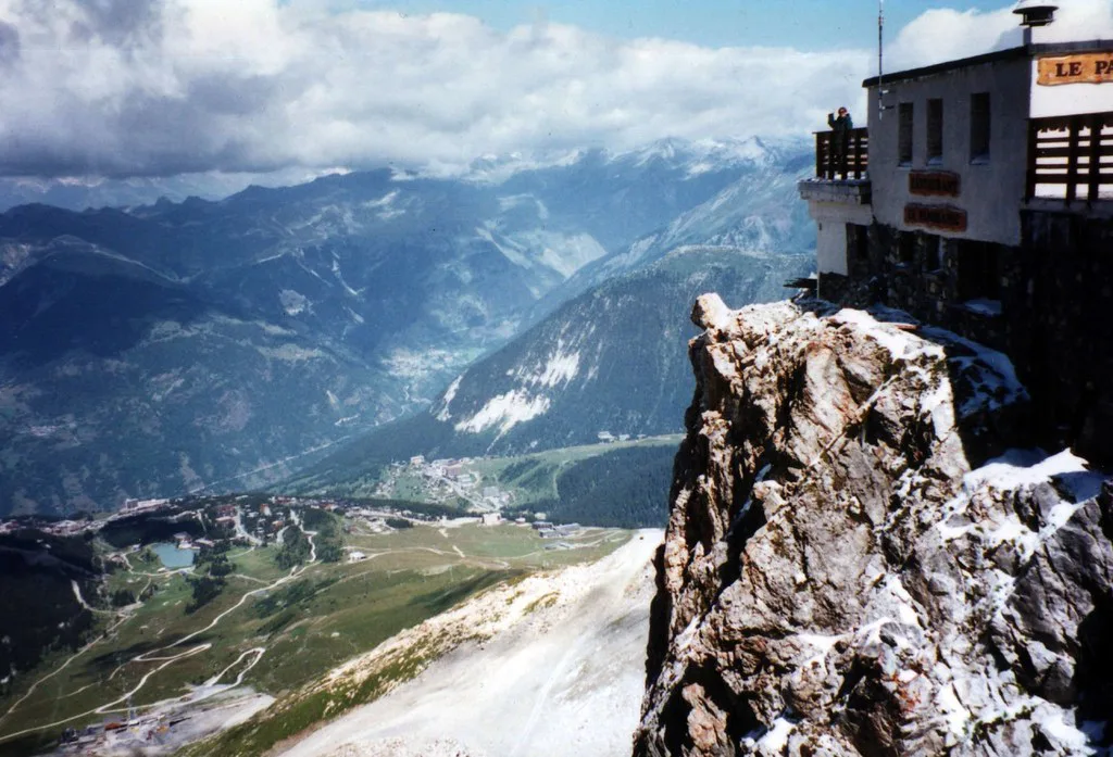 Mum waves from restaurant balcony above Courchevel